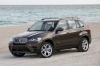 2013 BMW X5 xDrive50i in Sparkling Bronze Metallic from a front left three-quarter view